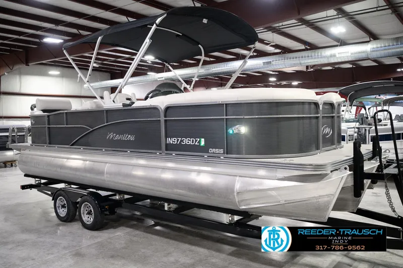 Slide: The Image of 2018 Manitou 23 Oasis RF VP pontoon boat on trailer in indoor showroom. - 5