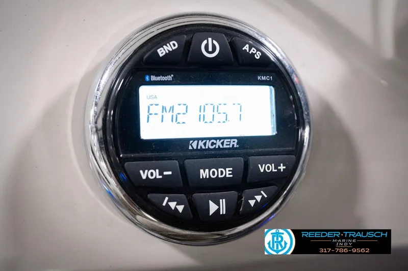 Slide: The Image of Kicker radio display on 2018 Manitou 23 Oasis RF VP boat, showing FM 105.7. - 44
