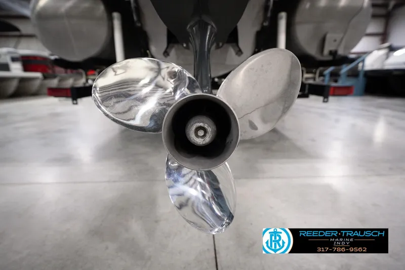 Slide: The Image of Propeller of 2018 Manitou 23 Oasis RF VP boat in showroom, Reeder Trausch Marine logo visible. - 65