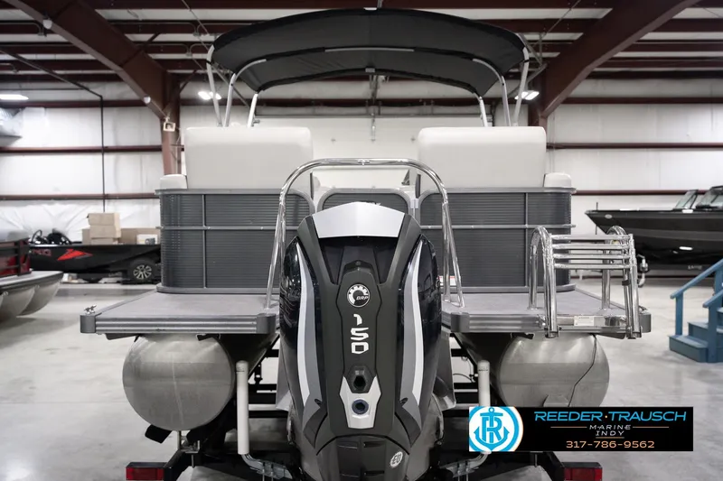 Slide: The Image of 2018 Manitou 23 Oasis RF VP pontoon boat with powerful outboard motor in a showroom. - 9