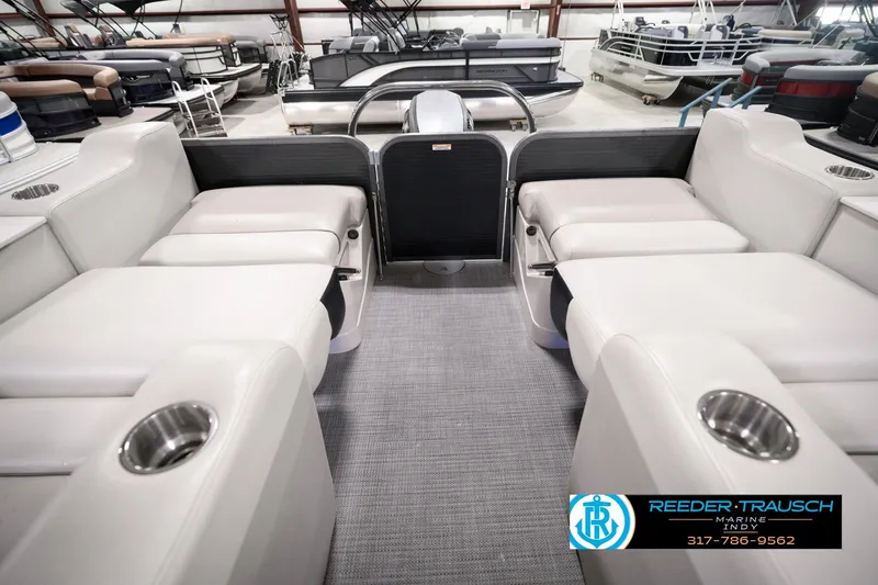 Slide: The Image of 2018 Manitou 23 Oasis RF VP pontoon boat interior with plush seating and cup holders. - 38
