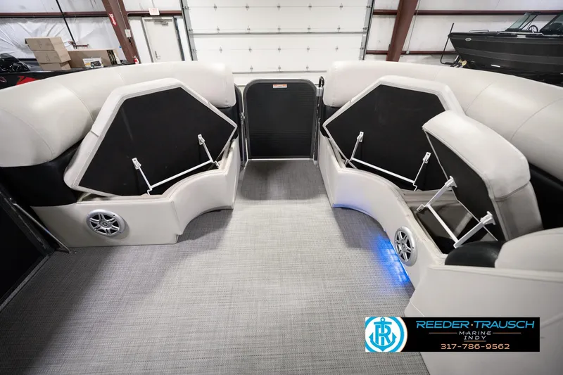 Slide: The Image of Interior of a 2018 Manitou 23 Oasis RF VP pontoon boat with open storage compartments. - 26