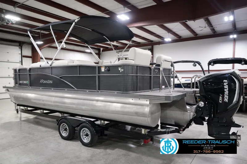 Slide: The Image of 2018 Manitou 23 Oasis RF VP pontoon boat with Evinrude motor in indoor showroom. - 10