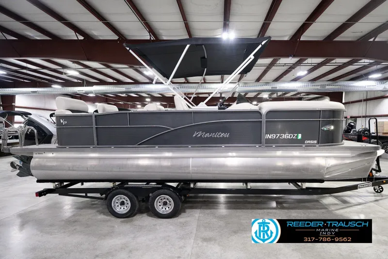 Slide: The Image of 2018 Manitou 23 Oasis RF VP pontoon boat in indoor showroom on trailer. - 6