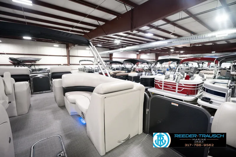 Slide: The Image of 2018 Manitou 23 Oasis RF VP pontoon boat in showroom with luxury seating. - 30