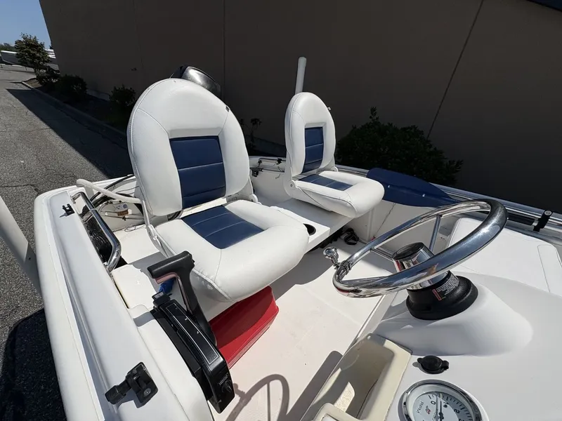 Slide: The Image of The image shows the cockpit of a 2009 Boston Whaler 130 Super Sport with two seats. - 4