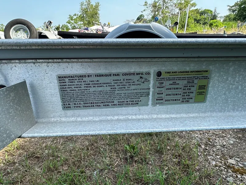 Slide: The Image of Close-up of a boat trailer with manufacturer details and warning labels. - 28