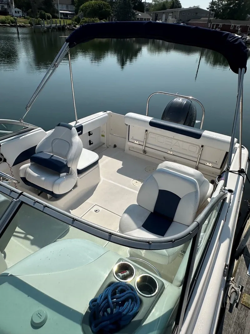 Slide: The Image of The image shows the cockpit of a 2018 Robalo R227 Dual Console boat with two seats. - 8