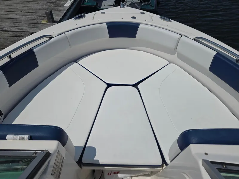 Slide: The Image of The image shows the bow area of a 2018 Robalo R227 Dual Console boat with cushioned seating. - 37