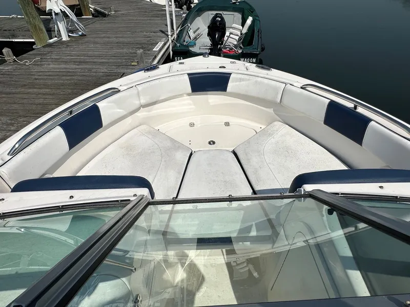 Slide: The Image of The image shows the bow of a 2018 Robalo R227 Dual Console boat at a dock. - 12