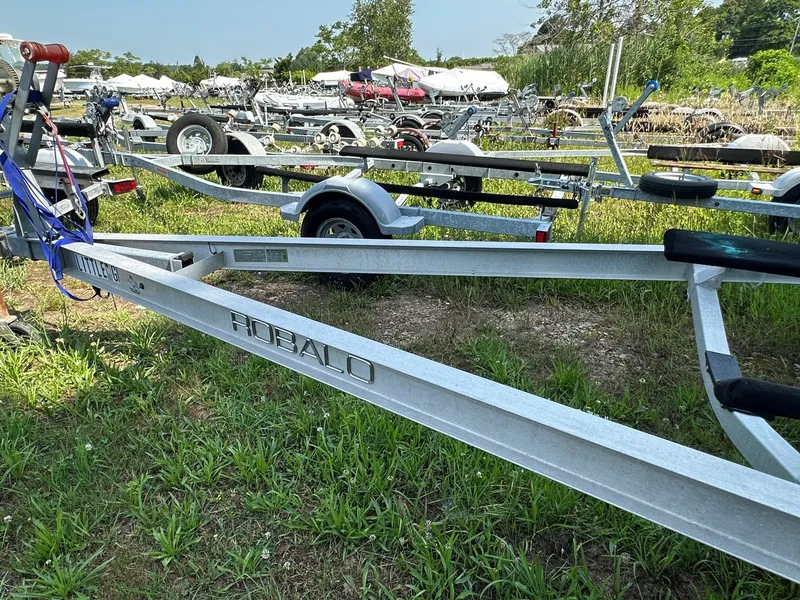 Slide: The Image of A Robalo boat trailer sits on grass, surrounded by other trailers and boats. - 27