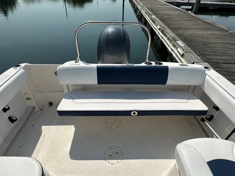 Slide: The Image of 2018 Robalo R227 Dual Console at dock with seating and motor. - 16