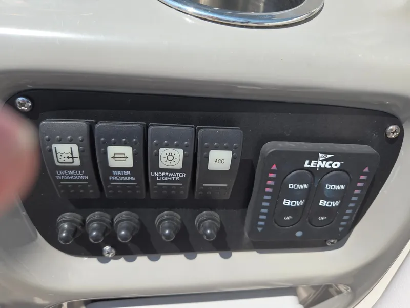 Slide: The Image of Close-up of a control panel with switches for livewell, water, underwater lights, and Lenco control. - 33