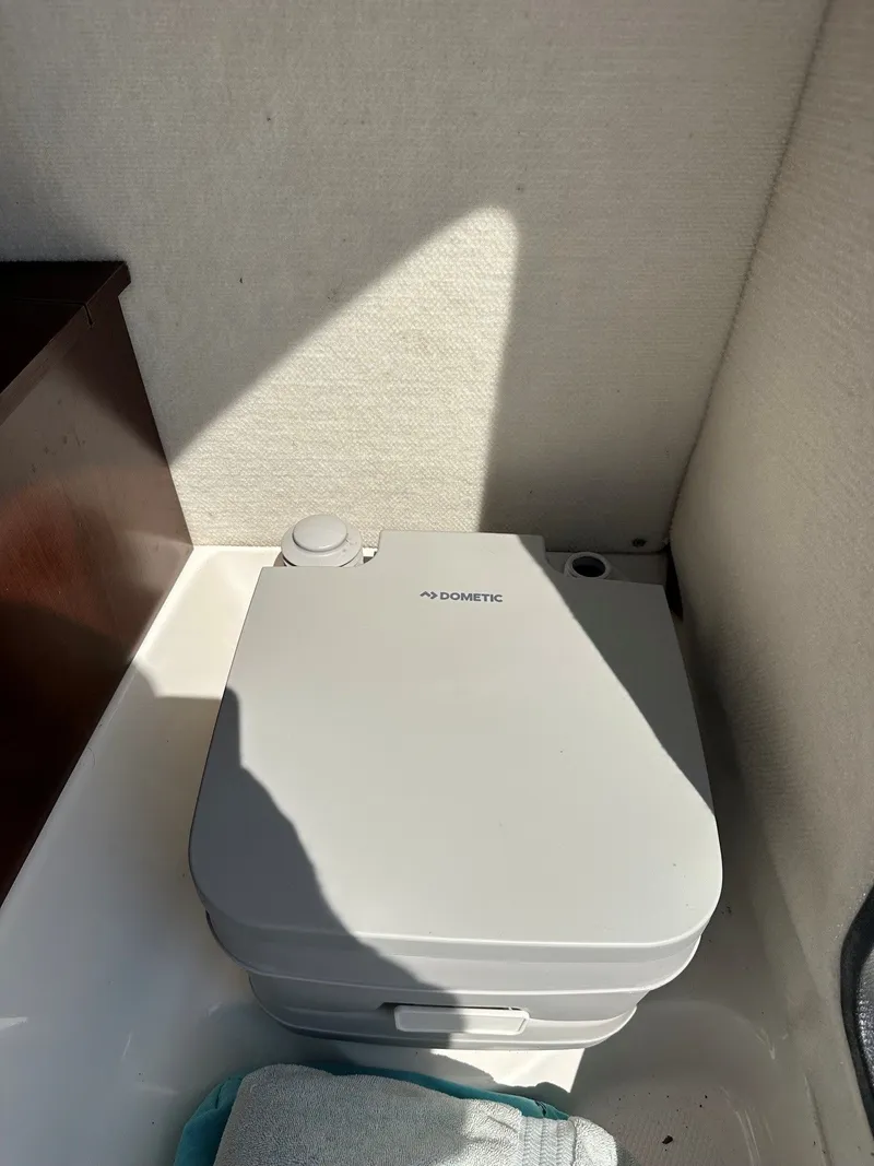 Slide: The Image of A portable Dometic toilet system inside a boat. - 21