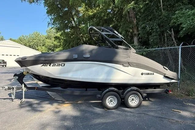 Slide: The Image of 2023 Yamaha Boats AR220 on trailer, covered, parked outdoors. - 14