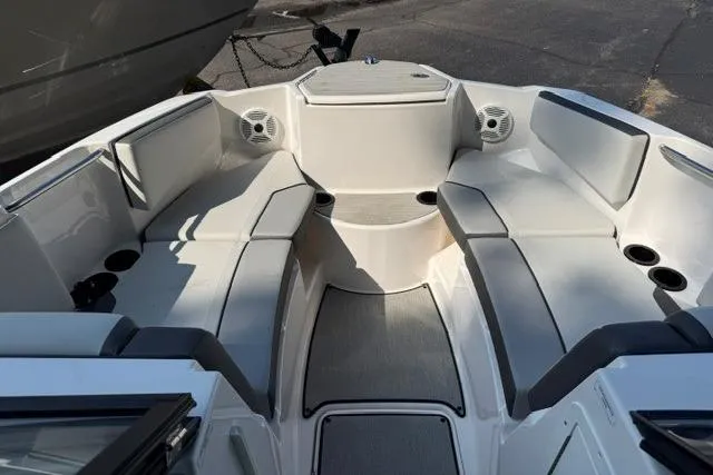 Slide: The Image of 2023 Yamaha Boats AR220 interior with spacious seating and cup holders. - 10