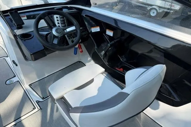 Slide: The Image of 2023 Yamaha Boats AR220 cockpit with steering wheel and captain's chair. - 7
