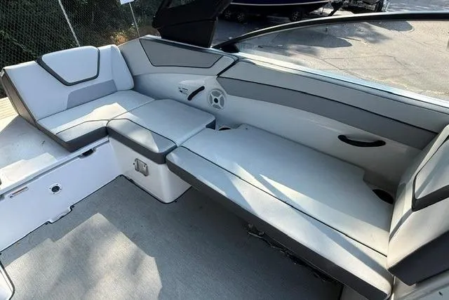 Slide: The Image of 2023 Yamaha Boats AR220 interior with sleek, modern seating and spacious layout. - 6
