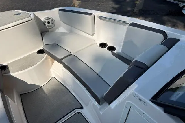 Slide: The Image of 2023 Yamaha Boats AR220 interior seating with cup holders and speaker system. - 8