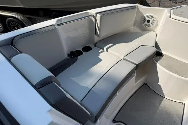 Slide: The Image of 2023 Yamaha Boats AR220 interior seating with cup holders and speaker. - 11