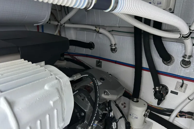 Slide: The Image of Engine room of 2022 Sabre 45 Salon Express with visible hoses and components. - 43