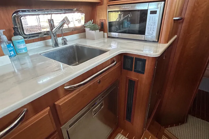 Slide: The Image of Modern kitchen area in 2022 Sabre 45 Salon Express yacht with sink and microwave. - 39
