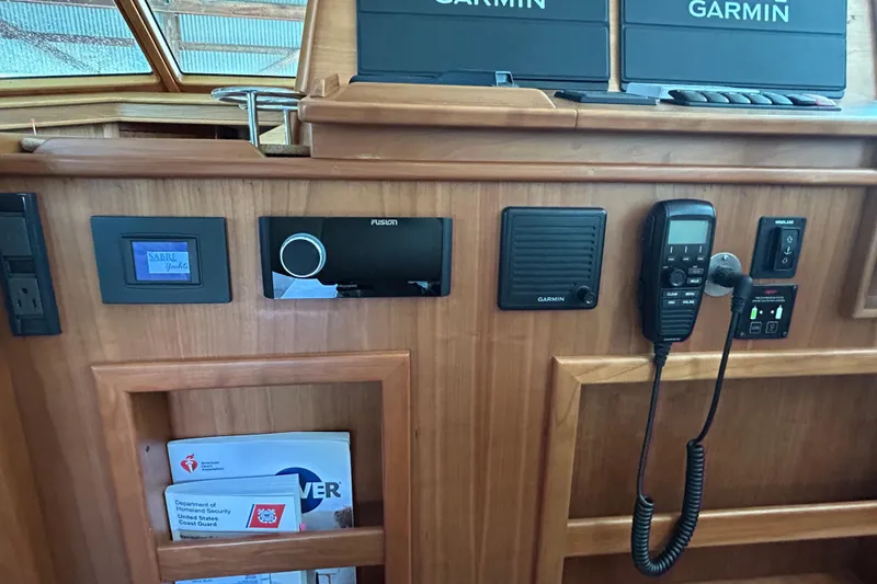 Slide: The Image of 2022 Sabre 45 Salon Express yacht dashboard with Garmin electronics and communication devices. - 24