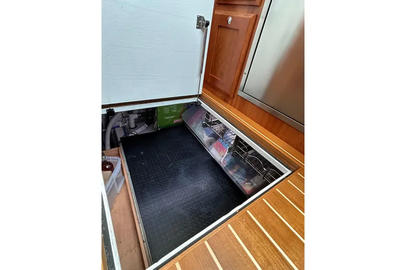 Slide: The Image of Underfloor storage compartment in 2022 Sabre 45 Salon Express yacht interior. - 56