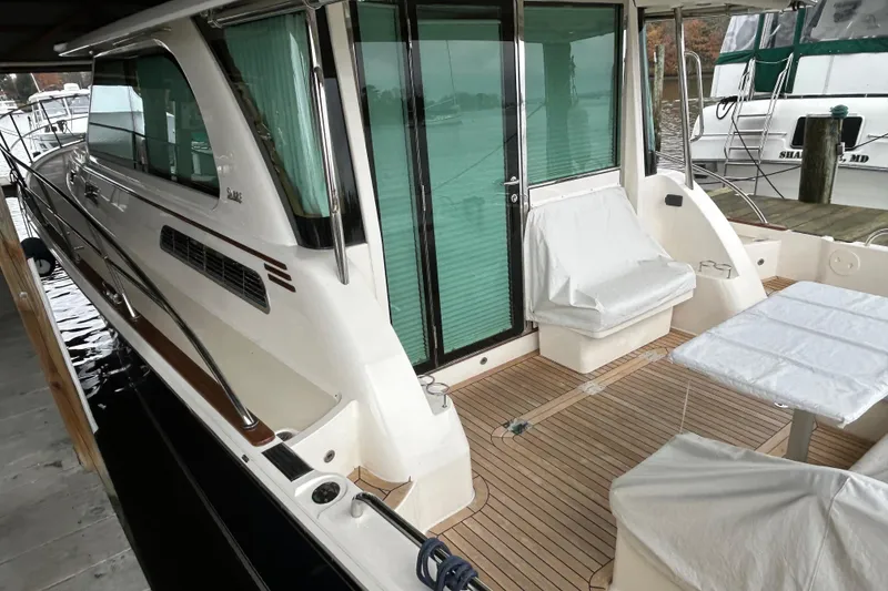 Slide: The Image of 2022 Sabre 45 Salon Express yacht with covered seating and sleek design. - 52