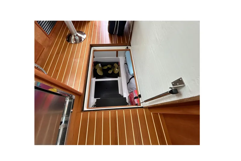 Slide: The Image of Open hatch on 2022 Sabre 45 Salon Express boat, revealing storage compartment. - 59