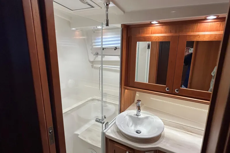 Slide: The Image of Luxurious bathroom in 2022 Sabre 45 Salon Express yacht with modern fixtures and wood accents. - 41