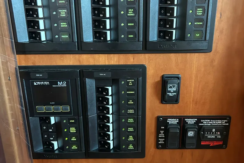 Slide: The Image of Control panel of a 2022 Sabre 45 Salon Express yacht with various switches and indicators. - 29