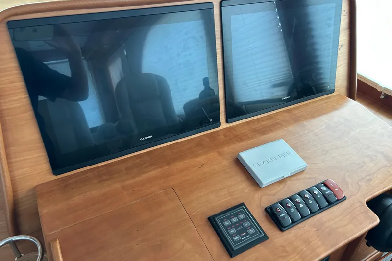 Slide: The Image of 2022 Sabre 45 Salon Express dashboard with dual Garmin screens and control panel. - 19