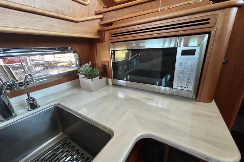 Slide: The Image of Modern kitchen in 2022 Sabre 45 Salon Express with microwave and sink. - 30
