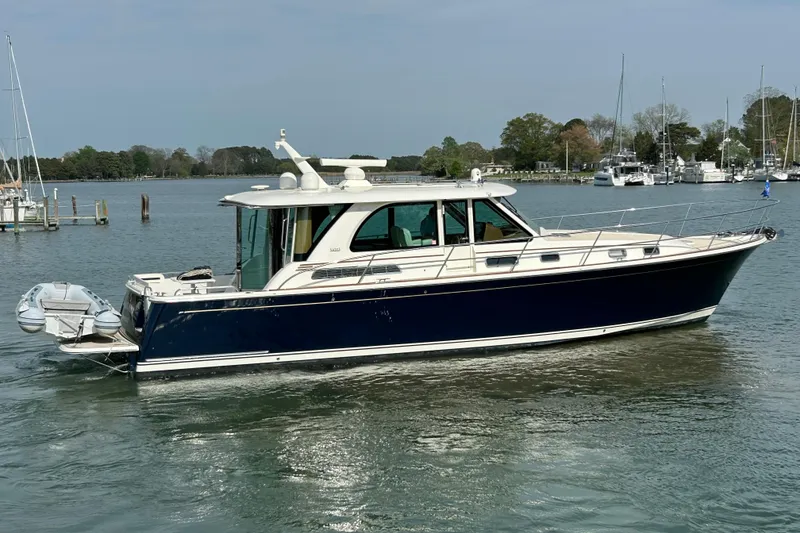 Slide: The Image of 2022 Sabre 45 Salon Express yacht on calm water, side view. - 2