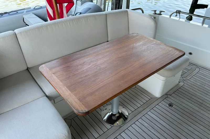 Slide: The Image of Luxury seating area on 2022 Sabre 45 Salon Express yacht with wooden table. - 8