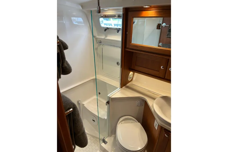 Slide: The Image of Luxurious bathroom in 2022 Sabre 45 Salon Express yacht with modern fixtures and wood accents. - 57