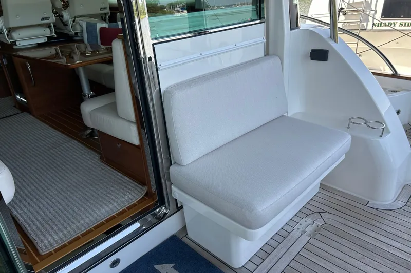 Slide: The Image of 2022 Sabre 45 Salon Express interior with cushioned seating and wooden flooring. - 11