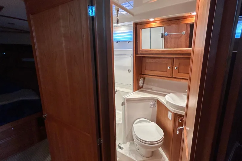 Slide: The Image of Luxurious bathroom interior of 2022 Sabre 45 Salon Express yacht, featuring wood cabinetry. - 42