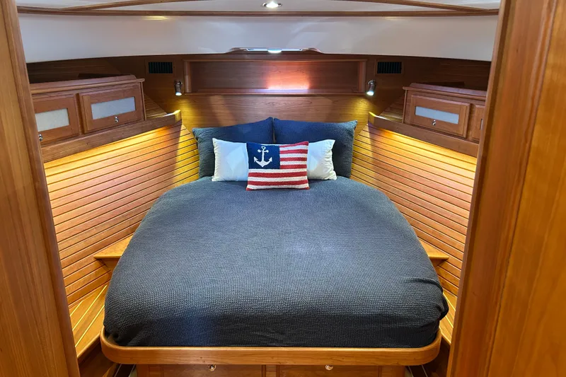 Slide: The Image of Luxurious 2022 Sabre 45 Salon Express cabin with cozy bedding and nautical decor. - 56