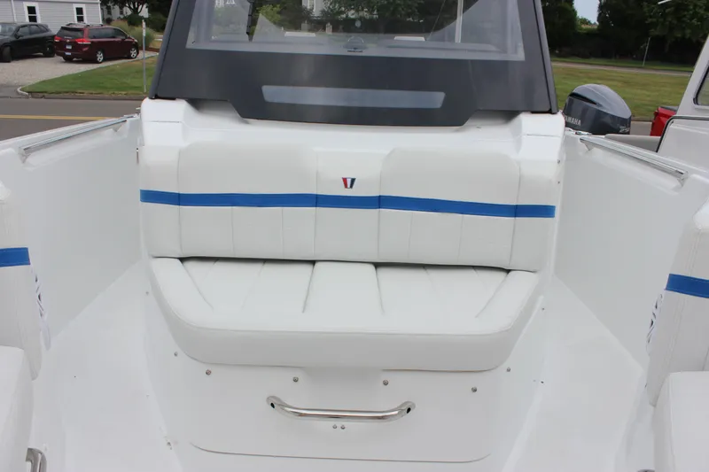 Slide: The Image of 2027 Wellcraft 28 T-Top boat interior with white seating and blue accents. - 52