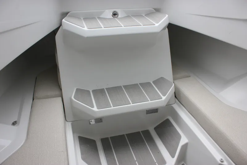 Slide: The Image of Interior view of 2027 Wellcraft 28 T-Top boat with cushioned seating and steps. - 60