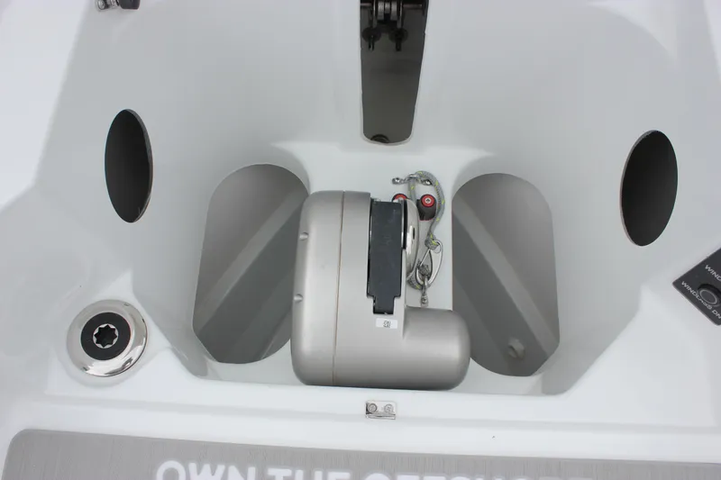 Slide: The Image of Wellcraft 28 T-Top 2027 boat storage compartment with winch and rope. - 44