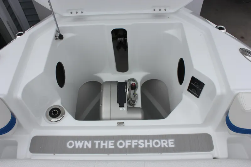 Slide: The Image of 2027 Wellcraft 28 T-Top boat storage compartment with "Own the Offshore" text. - 43