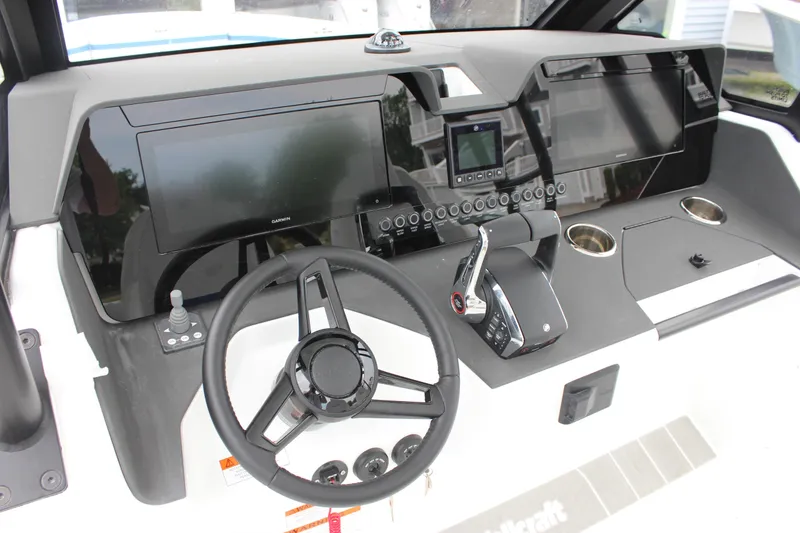 Slide: The Image of Dashboard of 2027 Wellcraft 28 T-Top boat with modern controls and displays. - 28