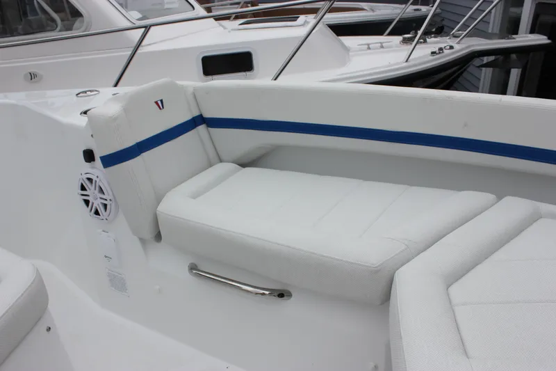 Slide: The Image of 2027 Wellcraft 28 T-Top boat interior with white seating and blue accents. - 54