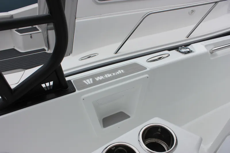 Slide: The Image of 2027 Wellcraft 28 T-Top boat interior with cup holders and sleek design. - 27