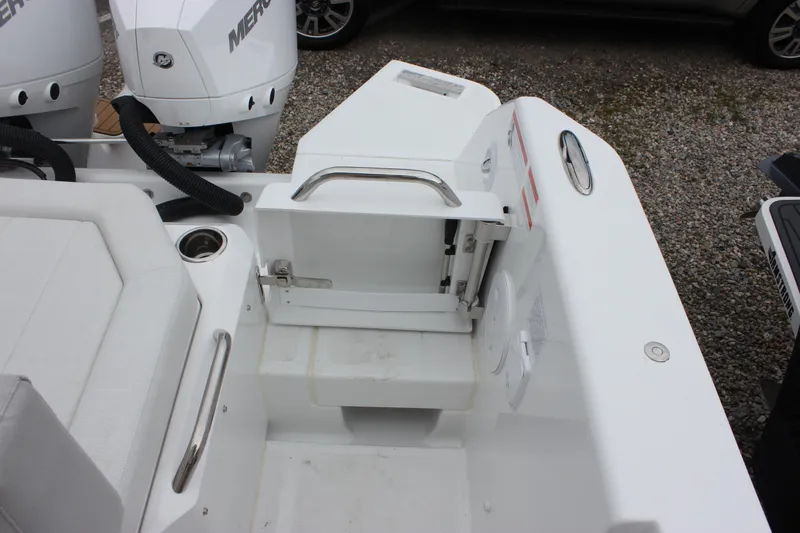 Slide: The Image of 2027 Wellcraft 28 T-Top boat stern with seating and dual Mercury outboard engines. - 16