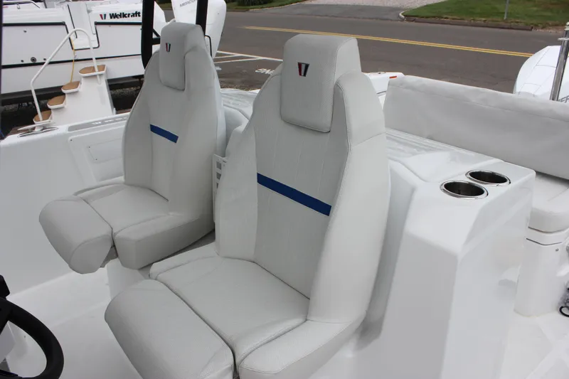 Slide: The Image of 2027 Wellcraft 28 T-Top boat interior with modern seating and cup holders. - 33