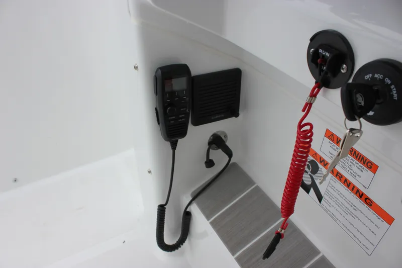 Slide: The Image of Control panel of 2027 Wellcraft 28 T-Top boat with radio and ignition keys. - 36